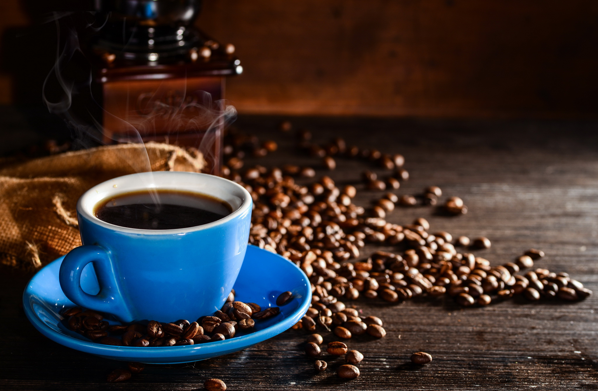 cup-coffee-with-coffee-beans-grinder-background.jpg